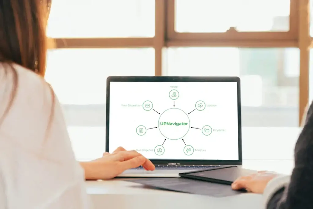 Two women are viewing the workflow of our unclaimed property software UPNavigator